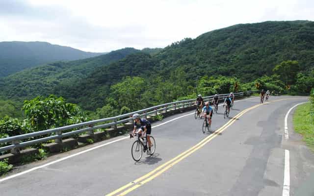 Group of cyclists descending a mountain road near Sun Moon Lake, Taiwan
