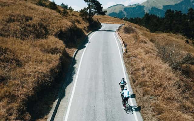 Cyclist riding a high-altitude alpine road on Taiwan's KOM route