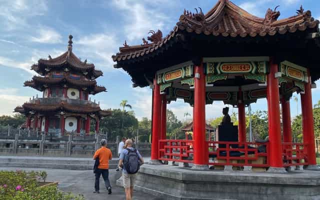 Visitors exploring a traditional park with pagodas in Taipei, Taiwan