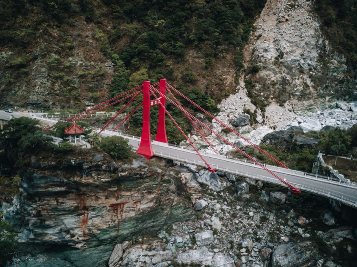 Red suspension bridge spanning Taroko Gorge above the Liwu River, at the entrance to the Taiwan KOM route