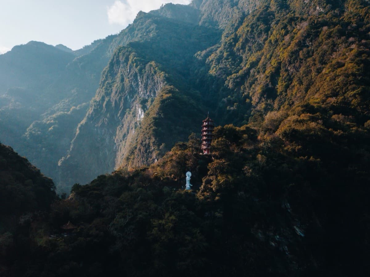 Aerial view of Xiangde Temple pagoda rising above the forest in the mountains above Tianxiang, Taroko Gorge
