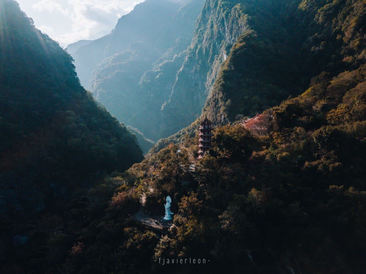 Aerial view of Xiangde Temple pagoda and Buddha statue set into the forested mountains above Tianxiang at the end of Taroko Gorge