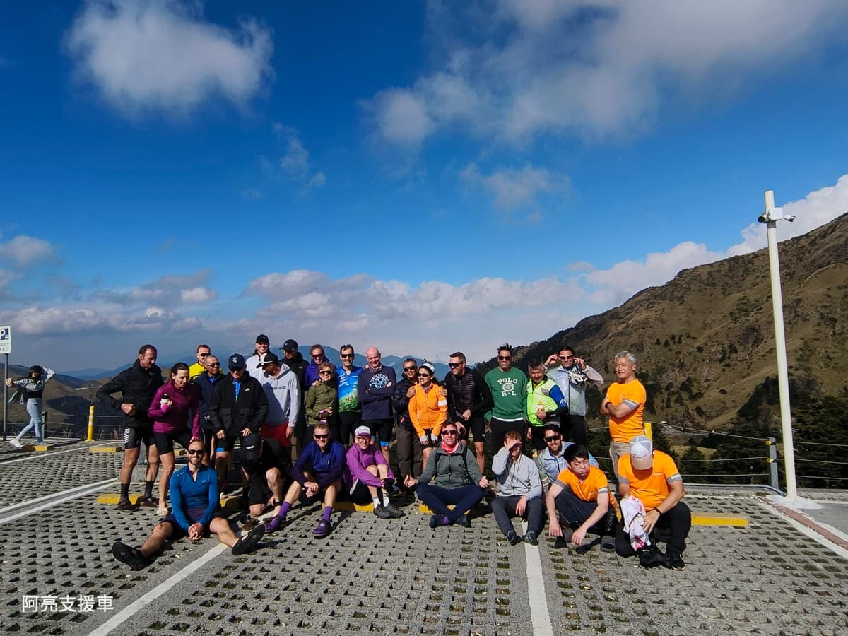 Pedal Taiwan group celebrating at Wuling Pass summit, 3,275m, after completing the Taiwan KOM climb