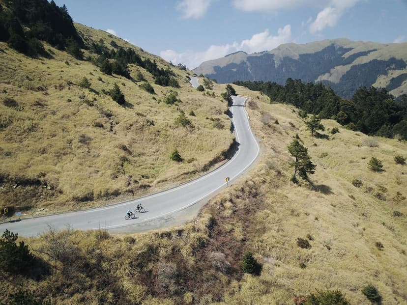 A cyclist on a winding alpine road climbing into the Taiwan high mountains