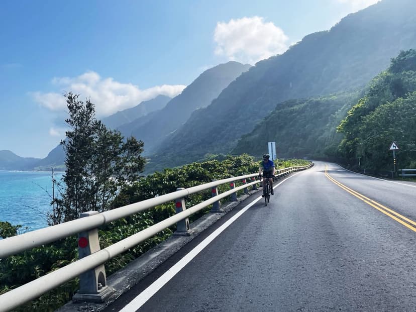 Cyclist riding the east coast highway in Taiwan with the Pacific Ocean on the left