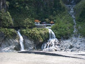 Image showing view of Eternal Spring Shrine in distance, surrounded by picturesque waterfalls